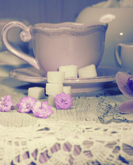 cup on wooden table with crochet doily