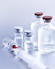 Vials and syringe, studio shot. Medical objects for vaccination. Vaccine drew up into a syringe.