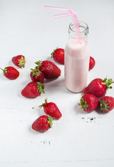Strawberry yogurt with fresh strawberries on a white wooden background