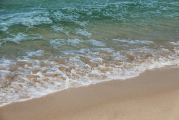 Fototapeta na wymiar Gentle waves on sand