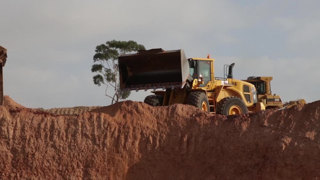 Yellow loader Pouring sand