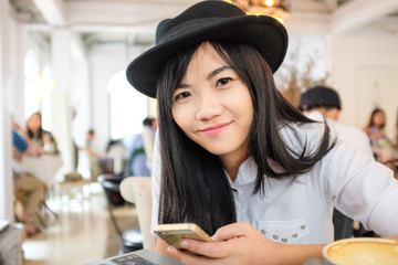 Young asian woman drinking coffee at cafe