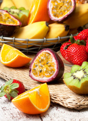 Obraz na płótnie Canvas sliced passion fruit and tropical fruits