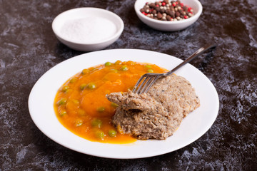 fish cakes and pumpkin puree with green peas