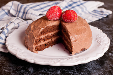 Delicious chocolate cake on plate on table