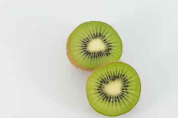 Kiwi fruit halves on white background