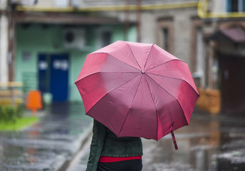 The woman under an umbrella.