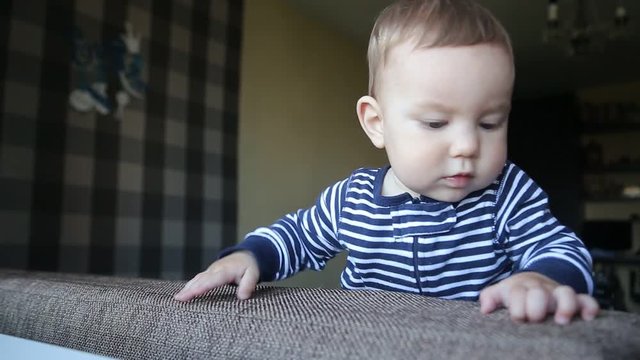 Cute Little Boy Playing On The Couch
