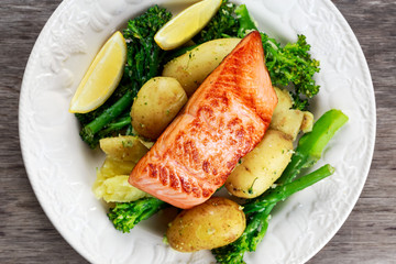 Pan fried Salmon Served with potatoes and tenderstem broccoli.