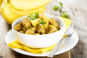 Meat curry with potatoes and banana