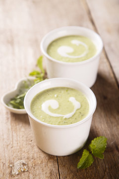 Zucchini soup with peas, decorated with egg
