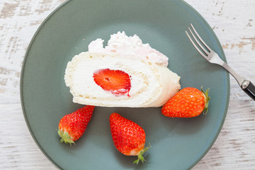 Homemade cake roll with strawberry cream