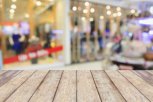Empty table and blur clothing store with bokeh background