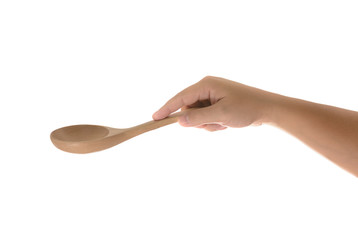 Hand holding a wooden kitchen spoon for stirring and tasting foo