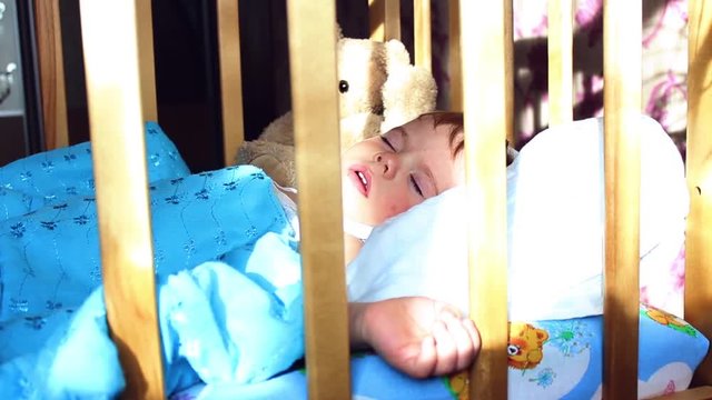 the baby sleeps in a cot