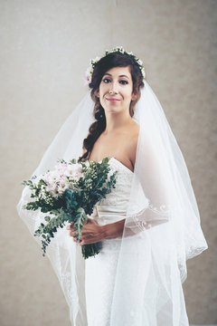 Portrait of beautiful bride in dress and veil