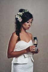 Portrait of unsmiling beautiful bride holding oil lamp