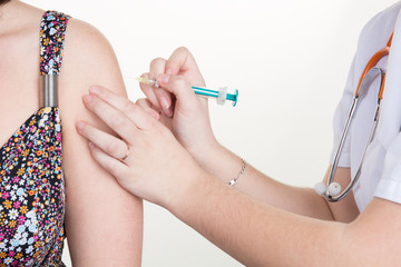 Woman doctor doing vaccine on her patient on arm