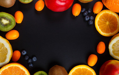 Fresh fruits oranges, kiwi, lemons, apples arranged in a group, natural still life for healthy food. Top view. Empty space for text.