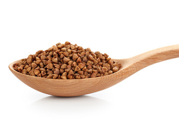 Wooden spoon with buckwheat isolated on white background.