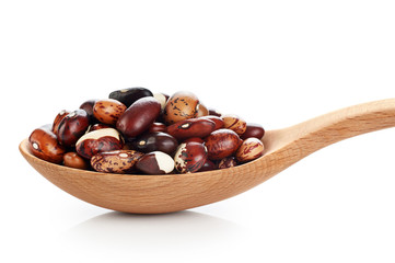 Wooden spoon with beans isolated on white background.