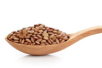 Wooden spoon with lentils isolated on white background.
