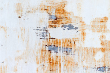 A background of peeling paint and rusty old metal