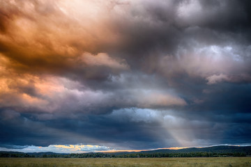 beautiful sunset sky with colored clouds and sun
