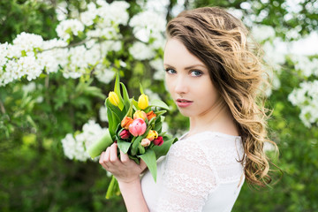 Fototapeta premium Woman with tulips / pretty woman with a bouquet tulips