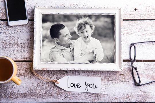 Fathers day composition. Picture of father with son in frame