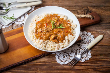 Cooked barley porridge and stew of pork.