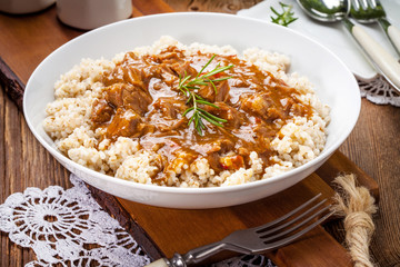 Cooked barley porridge and stew of pork.
