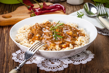 Cooked barley porridge and stew of pork.