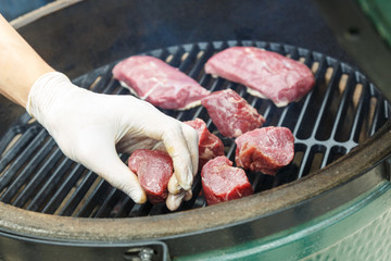 Man preparing fresh lamb meat on a grill