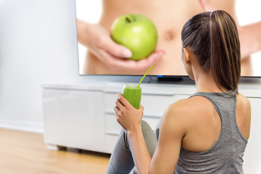 Healthy Eating Woman Drinking Green Smoothie Watching Television Online Education Tv Show About Nutrition And Weight Loss. Girl Sitting At Home Learning About Losing Weight With Vegetables And Fruits.