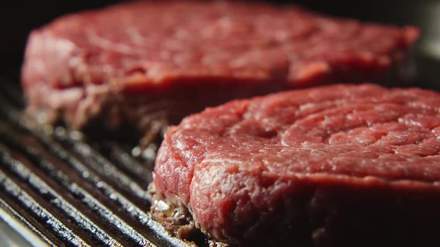 CLOSE UP: A blood beefsteak on a grill