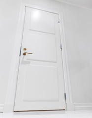 Naklejka premium Closed white domestic door. Empty interior