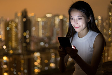 Woman use of mobile phone at night
