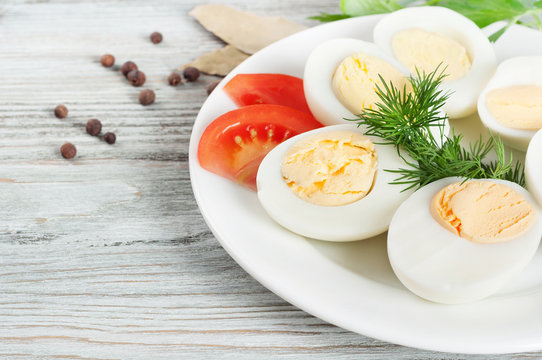 Boiled hen eggs in a white plate