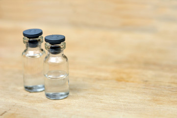 Medical vials for injection on wood table background