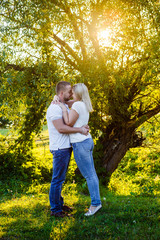 Young couple in the woods at sunset