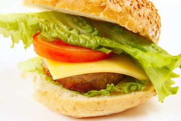 Big tasty sandwich with cheese and chop on a white background