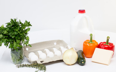 ingredient for a omelet , eggs, peppers, milk, cheese, 
