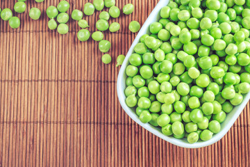 Green peas in white bowl