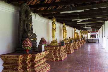 Golden buddha statue at Temple Phra That Hariphunchai in Lamphun, Province Lamphun, Thailand.
