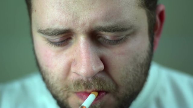 Funny man smoking close up
