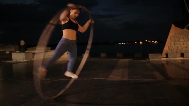 Woman on cyr wheel doing acrobatic trick