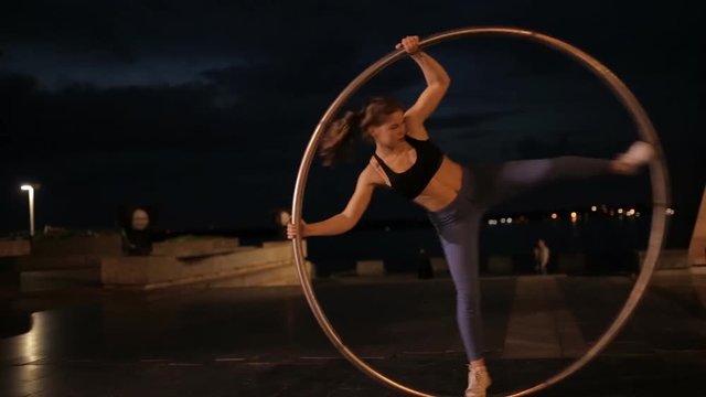 Woman on cyr wheel doing acrobatic trick