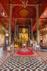 Fototapeta na wymiar Golden buddha statue at Temple Phra That Hariphunchai in Lamphun, Province Lamphun, Thailand. 