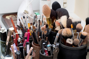 LITHUANIA, MAZEIKIAI - MAY 21, 2016: Used makeup brushes and cosmetics in beauty salon